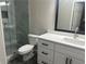 Updated bathroom with a walk-in shower and white vanity at 627 Huntington Nw Way, Lilburn, GA 30047