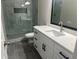 Bathroom boasts a quartz countertop, white cabinets, and a large shower at 627 Huntington Nw Way, Lilburn, GA 30047