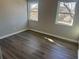 Well-lit bedroom with hardwood floors and neutral walls at 627 Huntington Nw Way, Lilburn, GA 30047