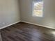 Spacious bedroom with hardwood floors and large window at 627 Huntington Nw Way, Lilburn, GA 30047