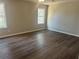 Large bedroom with hardwood floors and neutral walls at 627 Huntington Nw Way, Lilburn, GA 30047