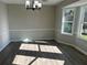 Bright dining room with neutral walls, wood floors, and chandelier at 627 Huntington Nw Way, Lilburn, GA 30047