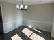 Dining room with neutral walls and wood floors, and chandelier at 627 Huntington Nw Way, Lilburn, GA 30047