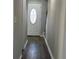 Bright entryway with hardwood floors and a white door at 627 Huntington Nw Way, Lilburn, GA 30047
