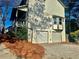 Two-car garage with white doors and pine straw landscaping at 627 Huntington Nw Way, Lilburn, GA 30047