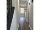 Hallway with dark wood stairs and light walls at 627 Huntington Nw Way, Lilburn, GA 30047