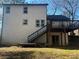 Two-story house with deck and stairs leading to backyard at 627 Huntington Nw Way, Lilburn, GA 30047
