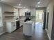 Modern kitchen with white cabinets, island, and stainless steel appliances at 627 Huntington Nw Way, Lilburn, GA 30047