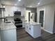 Modern kitchen with white cabinets, quartz countertops, and stainless steel appliances at 627 Huntington Nw Way, Lilburn, GA 30047