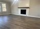 Spacious living room with hardwood floors and a fireplace at 627 Huntington Nw Way, Lilburn, GA 30047
