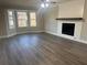 Bright living room featuring hardwood floors and a fireplace at 627 Huntington Nw Way, Lilburn, GA 30047