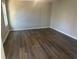 Bright living room featuring hardwood floors and neutral walls at 627 Huntington Nw Way, Lilburn, GA 30047