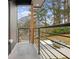 View of the home's modern balcony with black metal railings and a view of the treelined yard at 2208 Baker Nw Rd, Atlanta, GA 30318