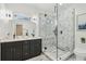Beautiful bathroom featuring a glass shower, a double vanity, and modern lighting fixtures at 2208 Baker Nw Rd, Atlanta, GA 30318