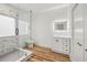 Modern bathroom featuring a glass shower, marble-like walls, and a sleek vanity with an illuminated mirror at 2208 Baker Nw Rd, Atlanta, GA 30318