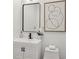 Modern bathroom with stylish black faucet, cabinet hardware, and framed mirror at 2208 Baker Nw Rd, Atlanta, GA 30318