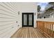 Outdoor deck with wood flooring and black framed glass doors at 2208 Baker Nw Rd, Atlanta, GA 30318