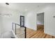 Bright hallway area featuring contemporary lighting and railing at 2208 Baker Nw Rd, Atlanta, GA 30318