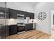 Modern kitchen with stainless steel appliances, dark cabinets, and marble countertops at 2208 Baker Nw Rd, Atlanta, GA 30318