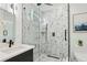 Luxurious shower with marble-patterned walls and glass doors, adding a touch of elegance at 2208 Baker Nw Rd, Atlanta, GA 30318