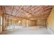 Unfinished basement with exposed beams and concrete flooring at 688 Calvet Way, Cumming, GA 30041