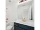 A bathroom featuring a blue vanity, toilet and modern gold fixtures at 688 Calvet Way, Cumming, GA 30041