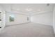 Spacious bedroom with tray ceilings and recessed lighting featuring natural light from two windows at 688 Calvet Way, Cumming, GA 30041
