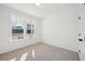 Bright bedroom with plush carpet, a large window, and white walls, creating a serene and inviting space at 688 Calvet Way, Cumming, GA 30041