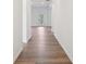 Bright hallway with light wood flooring leading to a sunlit room, showcasing the home's open and airy design at 688 Calvet Way, Cumming, GA 30041