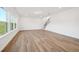 Bright living room with hardwood floors and large windows offering natural light and views at 688 Calvet Way, Cumming, GA 30041
