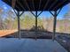 Covered patio with wooded views and unfinished yard at 688 Calvet Way, Cumming, GA 30041