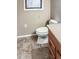 Small bathroom with toilet and wood-look vanity at 4395 Fence Rd, Auburn, GA 30011