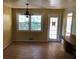 Bright dining room featuring hardwood floors, a chandelier, and a large window with a backyard view at 138 Le Brun Ne Rd, Atlanta, GA 30342