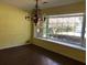 Bright living room with a chandelier and a large window overlooking greenery at 138 Le Brun Ne Rd, Atlanta, GA 30342