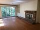 Open living room features a brick fireplace, built-in shelving, and large windows at 138 Le Brun Ne Rd, Atlanta, GA 30342