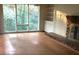 Bright living room featuring a brick fireplace, built-in shelving, and large windows at 138 Le Brun Ne Rd, Atlanta, GA 30342