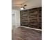 Bedroom with wood-look floors and accent wall at 2254 Wellington Cir, Lithonia, GA 30058
