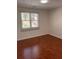 Bright bedroom with hardwood floors and a window at 2254 Wellington Cir, Lithonia, GA 30058