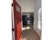 Bright entryway with red door opens to a view of the kitchen with stainless steel appliances at 2254 Wellington Cir, Lithonia, GA 30058