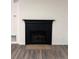 Black fireplace with a traditional mantel in the living room at 2254 Wellington Cir, Lithonia, GA 30058