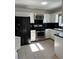 Kitchen features white cabinets, black countertops, and stainless steel appliances at 2254 Wellington Cir, Lithonia, GA 30058
