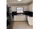 White kitchen cabinets, black countertops, and stainless steel appliances at 2254 Wellington Cir, Lithonia, GA 30058