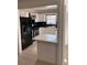 Kitchen features white cabinets, black countertops, and breakfast bar at 2254 Wellington Cir, Lithonia, GA 30058