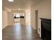 Living room with hardwood floors and a fireplace, open to the kitchen at 2254 Wellington Cir, Lithonia, GA 30058