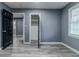 Bright bedroom with grey walls, wood-look flooring, and access to other rooms at 4598 Flint Hill Rd, Austell, GA 30106