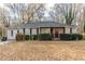 Charming ranch home with landscaped yard and red front door at 4598 Flint Hill Rd, Austell, GA 30106