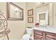 Well-appointed powder room with elegant vanity, decorative mirror, and refined decor at 100 Marietta Walk Trce, Marietta, GA 30064