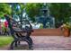 A close up of a park bench in Glover Park with a water fountain and flowers in the background at 100 Marietta Walk Trce, Marietta, GA 30064