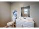 This bathroom features beadboard paneling and a white vanity with a framed mirror at 516 Richards Rd, White, GA 30184