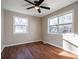 This bedroom features a modern ceiling fan, hardwood floors and lots of natural light at 516 Richards Rd, White, GA 30184